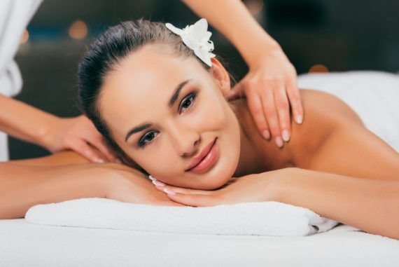 woman-relaxing-and-having-massage-at-spa-salon-and-looking-at-camera.jpg